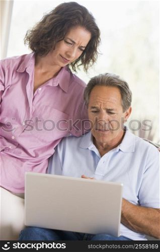 Couple in living room with laptop