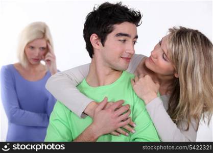 couple in love and jealous woman in background