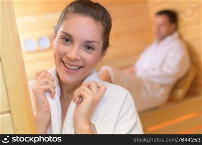 couple in love enjoying the sauna with white towels
