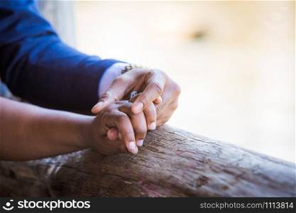 Couple in love holding hands together at day. Couple holding hands together