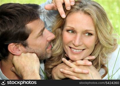 Couple in love lying in the grass