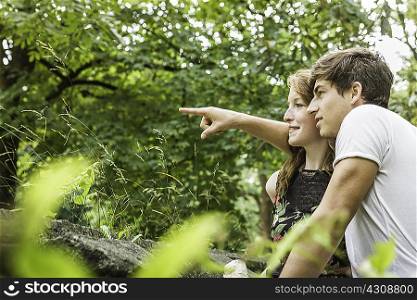 Couple in park, pointing finger