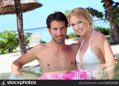 Couple in resort swimming pool