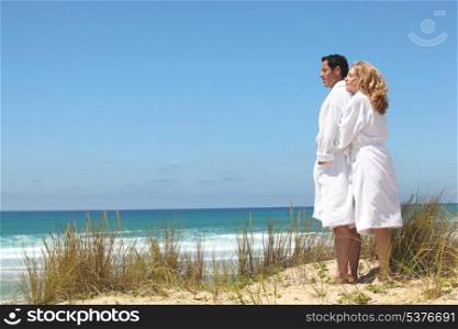 couple in robes on ta beach