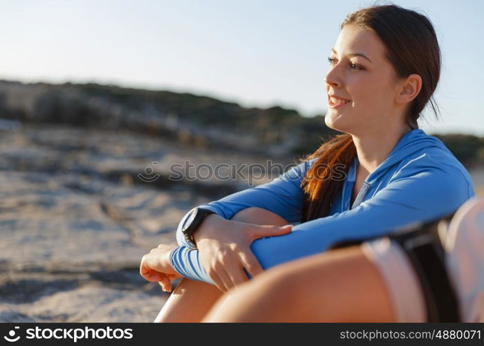 Couple in sport wear on beach. Young coulpe in sport wear sitting on beach