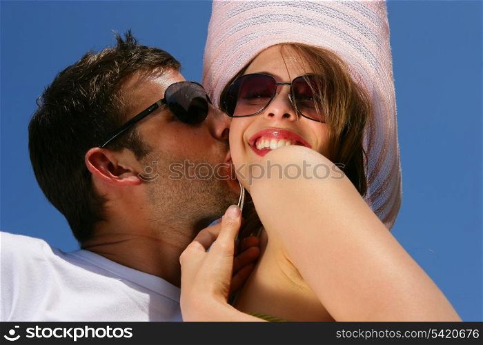 Couple in sunglasses kissing