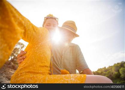 Couple in sunlight looking at camera smiling, Majorca, Spain