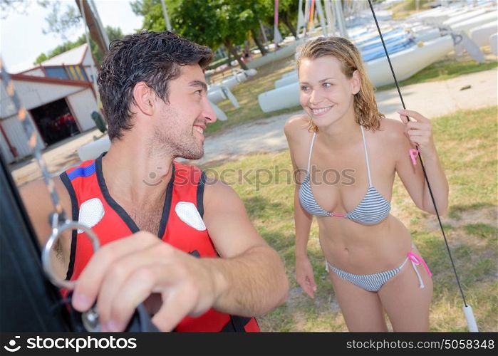 Couple in swimwear preparing for watersports activity