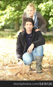Couple in the field with basket