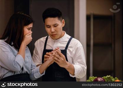 Couple in the Kitchen. Accident while Preparing Food. Cooking at Home