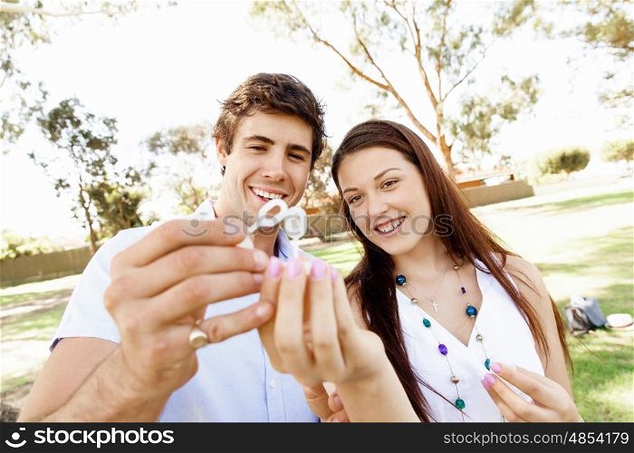 Couple in the park. Happy young couple in the park blowing bubbles