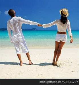 Couple in white on a tropical beach