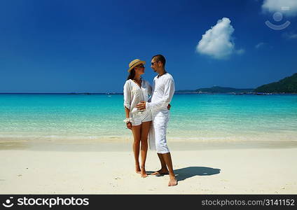 Couple in white on a tropical beach