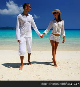 Couple in white on a tropical beach