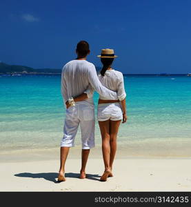 Couple in white on a tropical beach