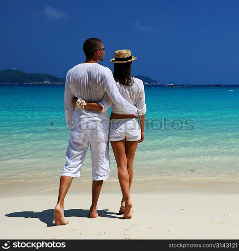 Couple in white on a tropical beach