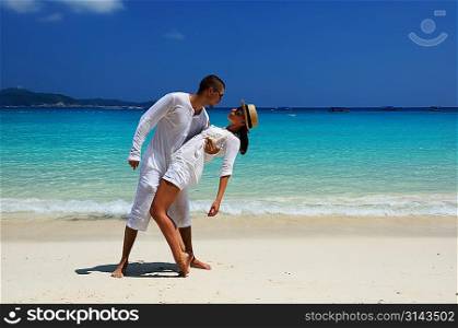 Couple in white on a tropical beach