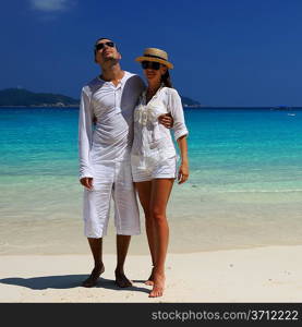 Couple in white on a tropical beach