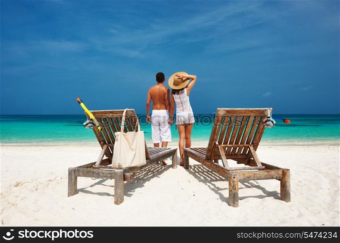 Couple in white on a tropical beach at Maldives