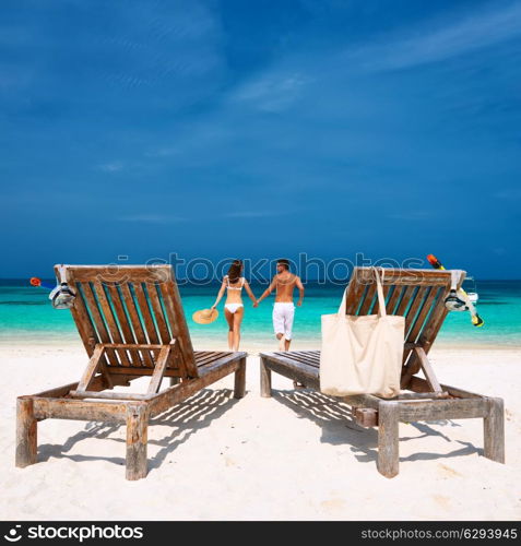 Couple in white running on a tropical beach at Maldives