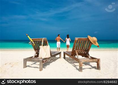 Couple in white running on a tropical beach at Maldives
