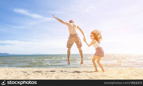 Couple is Jumping in beach