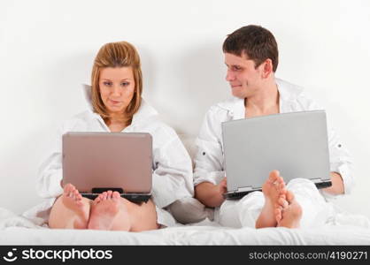 couple is sitting in bed at morning