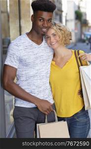 couple is standing and smiling at the camera