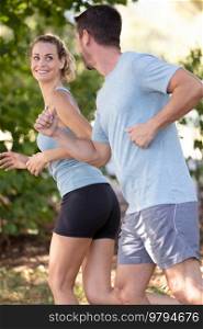 couple jogging and running outdoors in nature