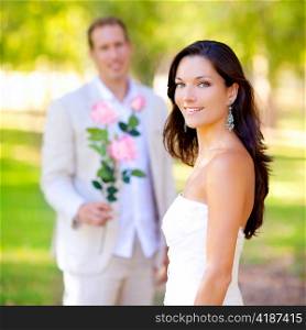 couple just married with man holding flowers in hand