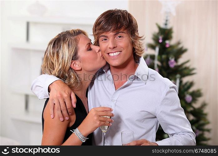 Couple kissing at Christmas