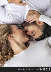 couple kissing bed home