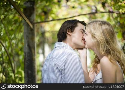 Couple kissing in garden