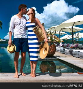 Couple kissing near poolside jetty at Seychelles