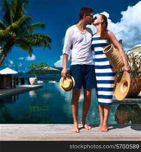 Couple kissing near poolside jetty at Seychelles