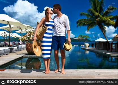 Couple kissing near poolside jetty at Seychelles