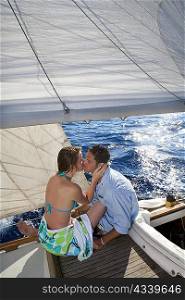Couple kissing on sailboat