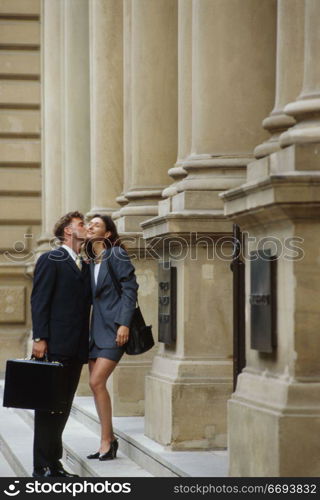 Couple Kissing Outside Building