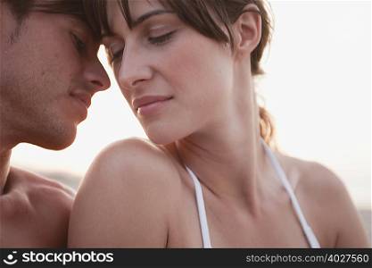 couple kissing sitting on the beach