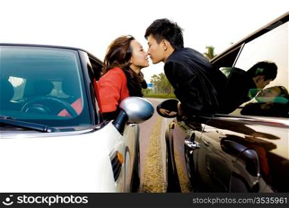 Couple kissing through car windows