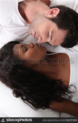 Couple laid in bed asleep