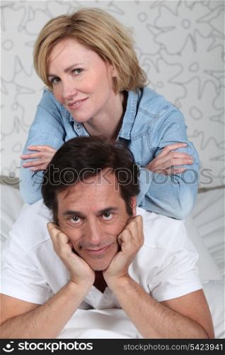 Couple laid on a bed