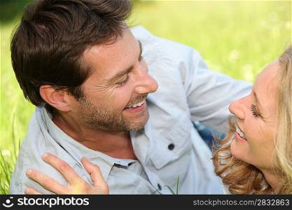 Couple laid on grass