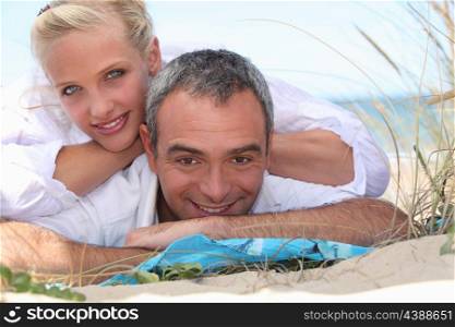 Couple laid together on beach