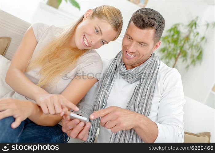Couple laughing at a text message