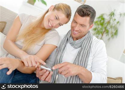 Couple laughing at a text message