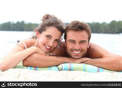 Couple laying by lake