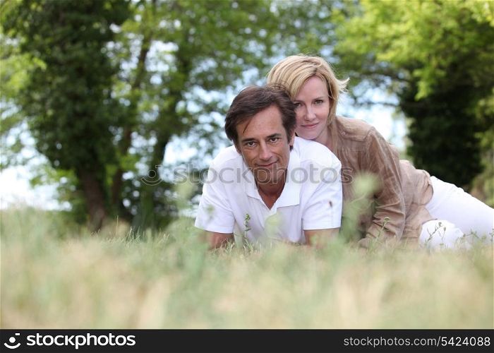 Couple laying in field