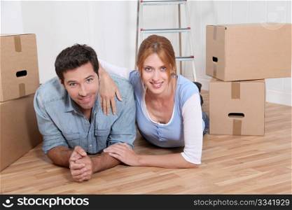 Couple laying on new house floor