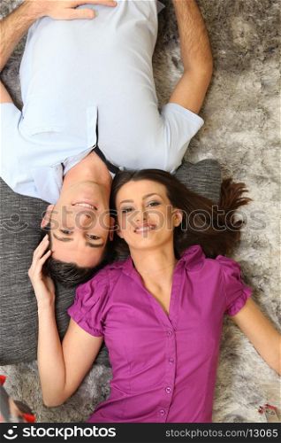 Couple laying on rug